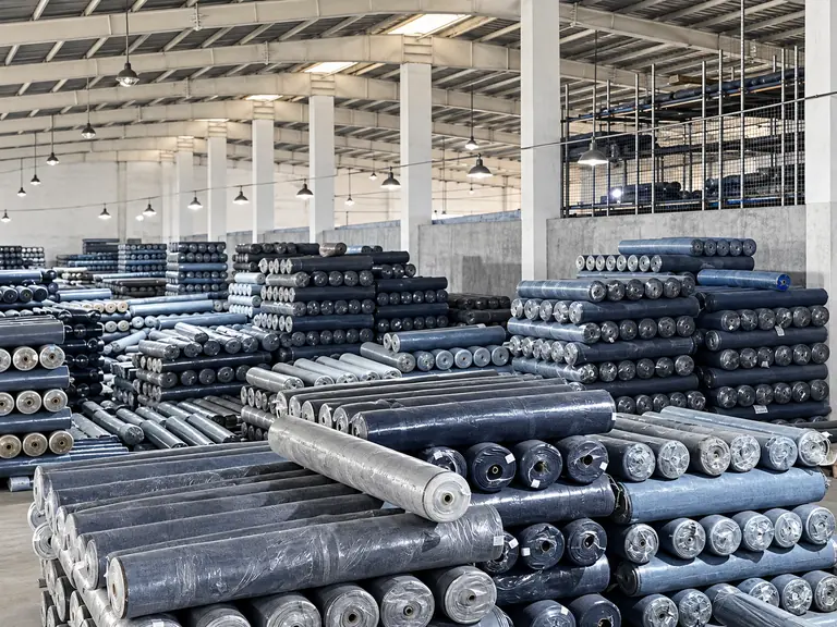 Stacks of denim fabric rolls available for sourcing